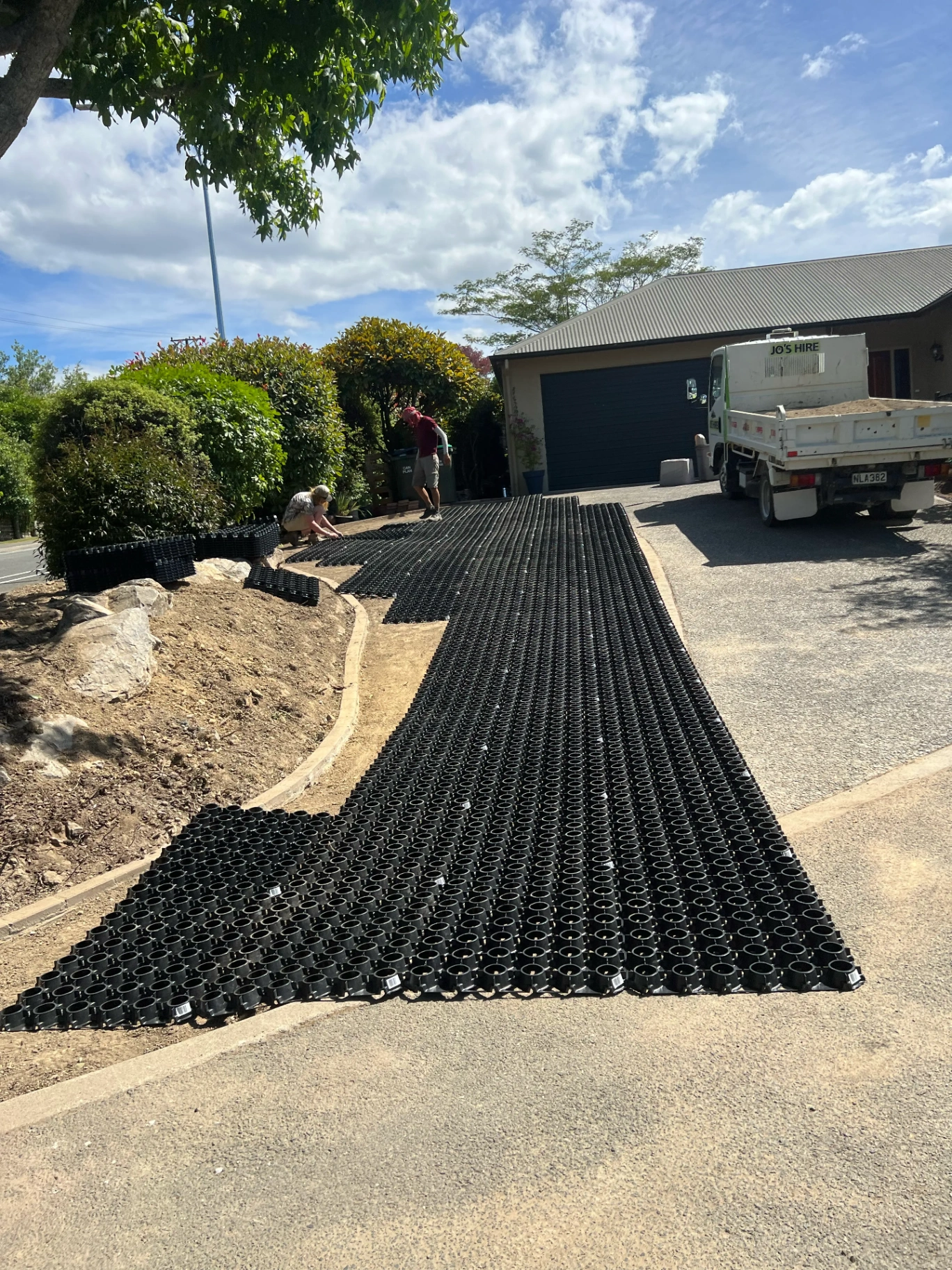 SurePave cellular base laid as foundation prep alongside a driveway