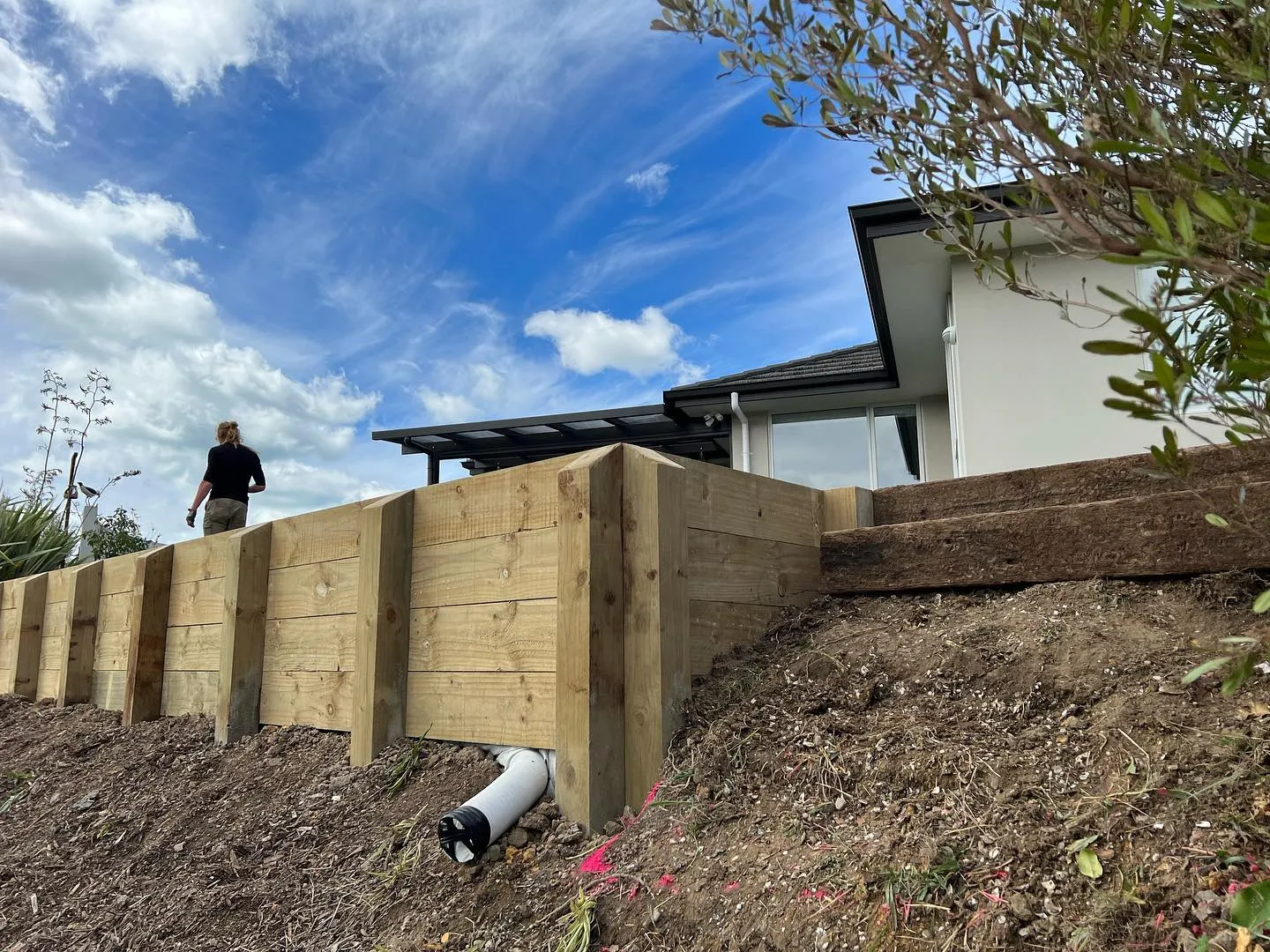 Timber retaining wall built into a slope