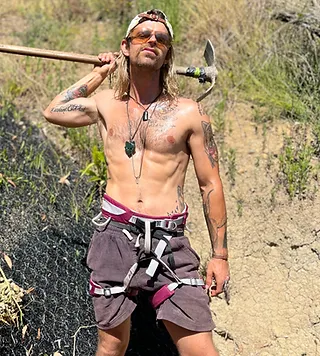 Crew member with mattock on a hillside job